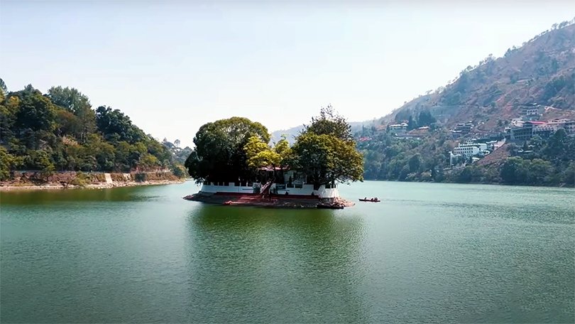 Picturesque Bhimtal Lake with an island in the center, a serene spot among the best places to visit in Nainital region.