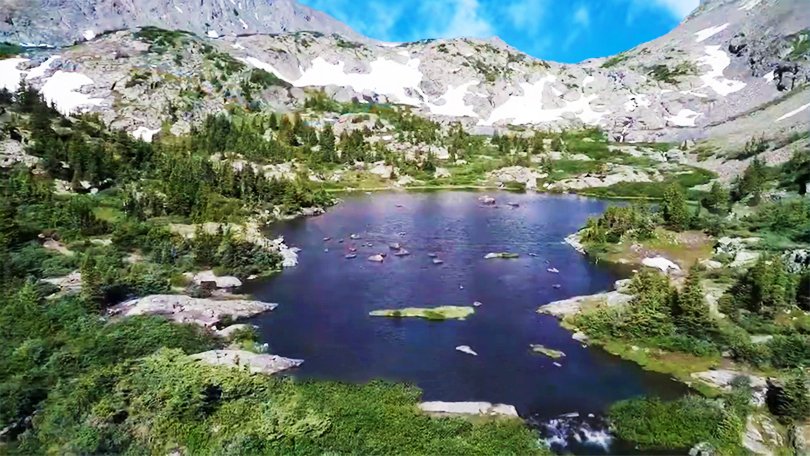 Serene blue waters of Chattrakund Lake surrounded by forest