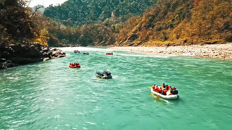 Tourists enjoying white water rafting on the Ganga River in Rishikesh