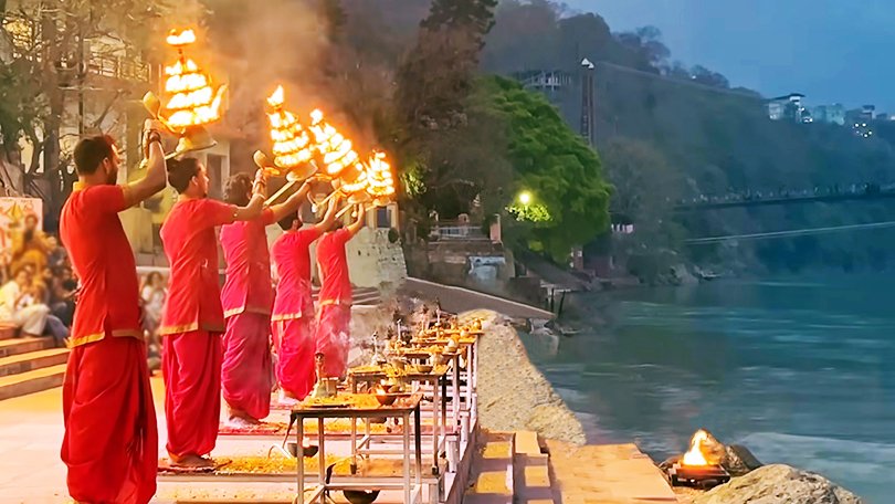 Devotees performing Ganga Aarti at Triveni Ghat, a sacred confluence and spiritual highlight in Rishikesh
