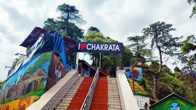 Panoramic view of Chakrata hill station in Uttarakhand with green valleys, pine forests, and snow-clad Himalayan peaks – complete Chakrata travel guide.