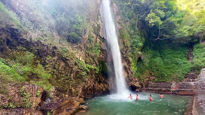 Scenic view of Tiger Falls in Chakrata, Uttarakhand – one of the highest waterfalls surrounded by lush green forest and a popular trekking and picnic spot.