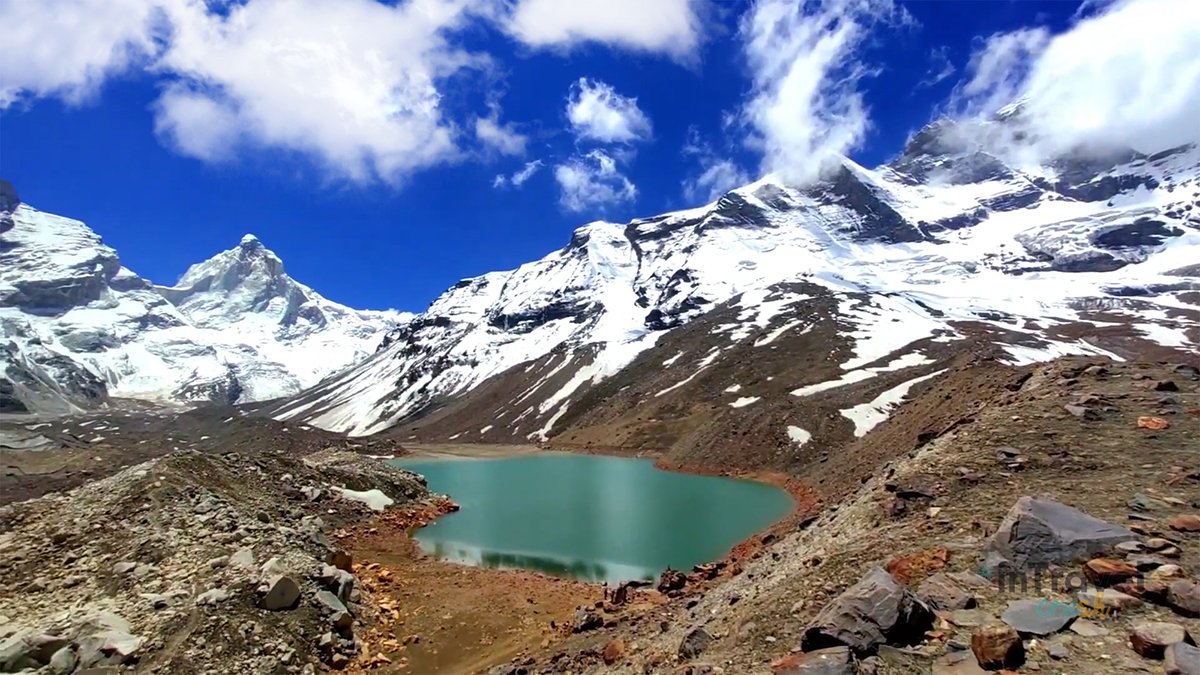 Breathtaking landscape view of Kedar Tal with crystal-clear blue lake reflecting Thalay Sagar peak