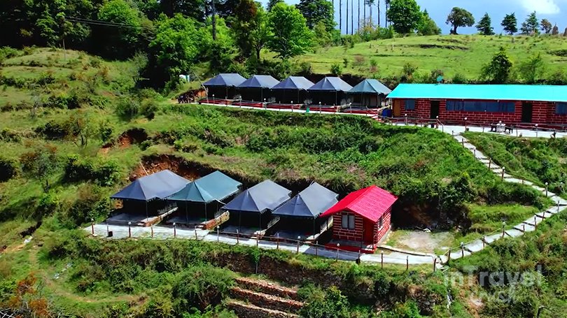Winter camping tents with evening bonfire in Kanatal