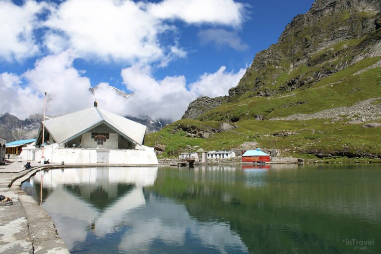 Sacred Hemkund Sahib Gurudwara beside the crystal-clear lake surrounded by snow-covered Himalayan peaks – Hemkund Sahib trek, Uttarakhand, India.