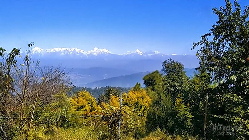 Sitla Village with forested hills, old cottages and clear views of the Himalayan range.