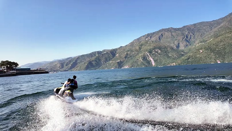Tehri Lake winter landscape with blue water and surrounding mountains with adventure boating experience